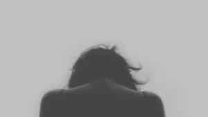 A blurry image of the back end of a person 's head.