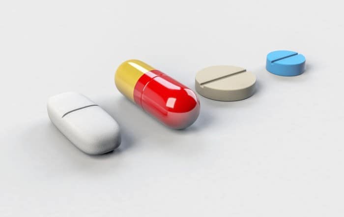 A group of pills and tablets sitting on top of a table.